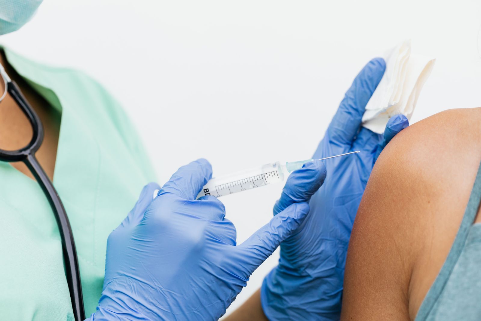 Clinician preparing a vitamin injection in a bright treatment room