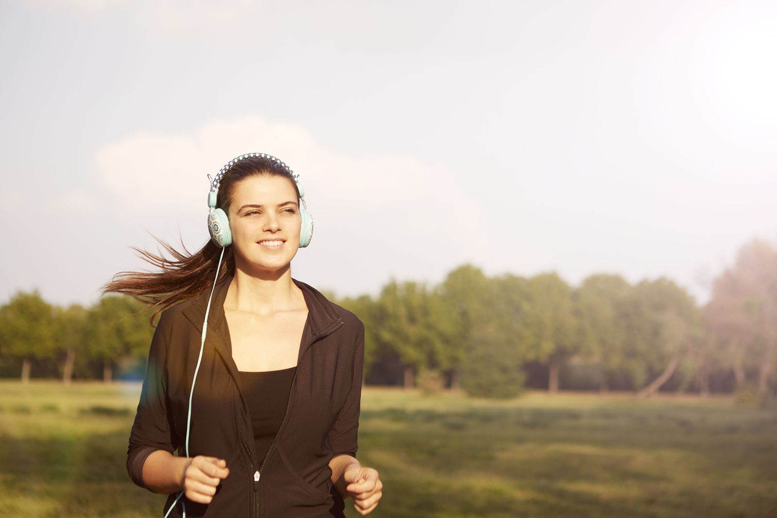 Woman out for a run in warm morning light