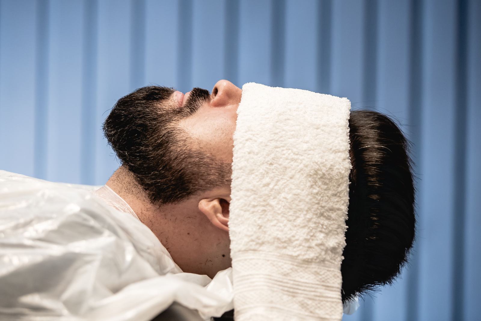 Man relaxing with a towel over his eyes during a spa appointment