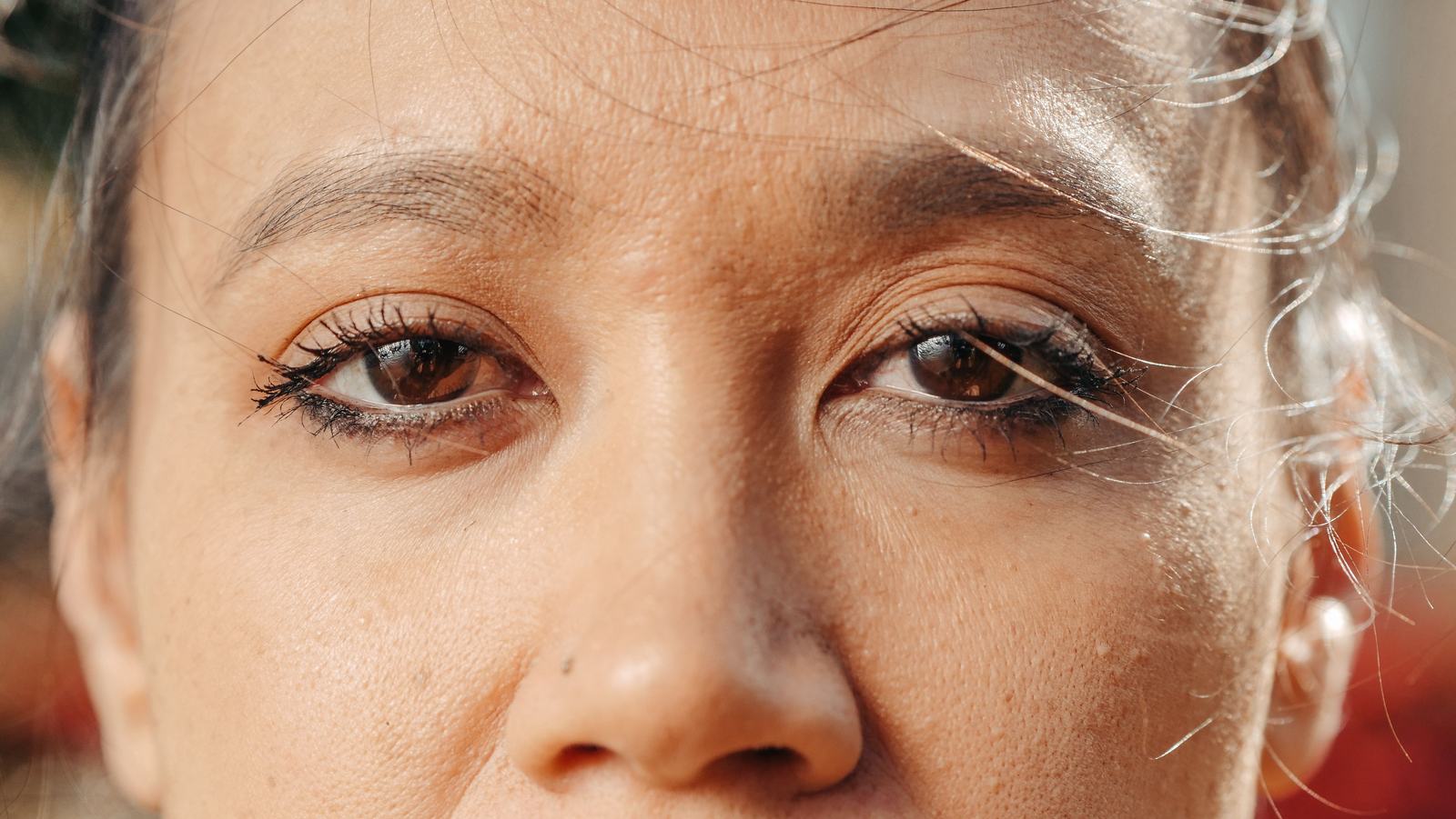Extreme close up of a woman's eyes showing skin texture around the eyelids