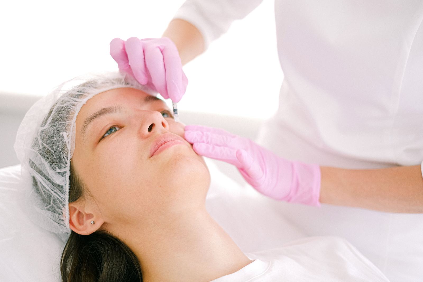 Woman receiving a cosmetic injection during a clinical aesthetic treatment